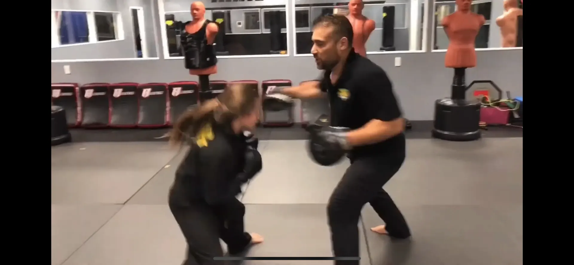 Impact instructor working with a student in the dojo